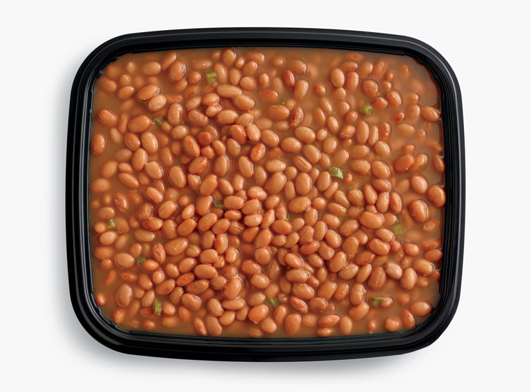 Open catering container of simmered pinto beans